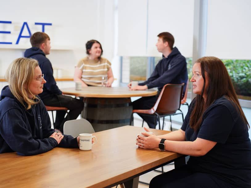 Lisa speaking with a colleague